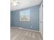 Bedroom features blue walls, carpeted floors, and a window with blinds at 6930 S Yukon Way, Littleton, CO 80128