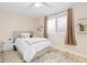 Cozy bedroom features a window and decorative pillows on the bed with a decorative area rug at 6930 S Yukon Way, Littleton, CO 80128