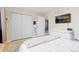 This bedroom has a closet, a dresser, and a TV on the wall, and a view into the hallway at 6930 S Yukon Way, Littleton, CO 80128