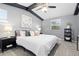 This bedroom features a vaulted ceiling with dark beams, a decorative painting, and a large window at 6930 S Yukon Way, Littleton, CO 80128