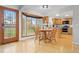 Cozy breakfast nook with hardwood floors, a large bay window, and views of the backyard at 6930 S Yukon Way, Littleton, CO 80128
