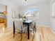 Bright dining room with hardwood floors, a large window, and a modern dining set at 6930 S Yukon Way, Littleton, CO 80128