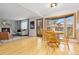 Dining room with hardwood floors, a wooden table, and a view into the living room at 6930 S Yukon Way, Littleton, CO 80128