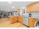 Open concept kitchen with stainless appliances, hardwood floors, and views into the living area at 6930 S Yukon Way, Littleton, CO 80128