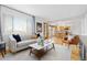 Bright living room with hardwood floors, large windows, and a comfortable sofa at 6930 S Yukon Way, Littleton, CO 80128