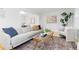 Cozy living room with neutral furniture, glass coffee table and hardwood floors at 6930 S Yukon Way, Littleton, CO 80128