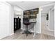 Home office featuring multiple monitors, a desk, chair, and plank flooring at 6930 S Yukon Way, Littleton, CO 80128