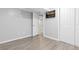 Finished room with gray wood-look flooring, a doorway, and a mounted TV at 6930 S Yukon Way, Littleton, CO 80128