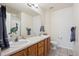 Shared bathroom with double sinks and a shower/tub combo at 4806 Jericho Ct, Denver, CO 80249