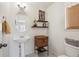 Convenient half-bathroom with pedestal sink and toilet at 4806 Jericho Ct, Denver, CO 80249