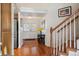 Hardwood floors and staircase leading upstairs; view of front door at 4806 Jericho Ct, Denver, CO 80249