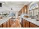 Kitchen with hardwood floors, white cabinets, and a large window at 4806 Jericho Ct, Denver, CO 80249
