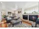 Cozy living room with hardwood floors, fireplace and comfortable seating at 4806 Jericho Ct, Denver, CO 80249