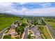 Aerial view featuring the home in a suburban neighborhood, surrounded by lush greenery and hills at 6950 Blue Mesa Ln, Littleton, CO 80125