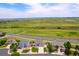 Aerial view of homes in a peaceful neighborhood, surrounded by picturesque green hills at 6950 Blue Mesa Ln, Littleton, CO 80125