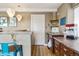 Bar area with custom cabinetry, pendant lighting, bar seating and convenient appliances, perfect for entertaining at 6950 Blue Mesa Ln, Littleton, CO 80125