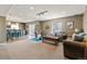Inviting finished basement with a carpeted living area, bar, exercise equipment, and ample space for entertaining at 6950 Blue Mesa Ln, Littleton, CO 80125
