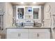 Modern bathroom with double sinks, stylish vanity, and ample storage space at 6950 Blue Mesa Ln, Littleton, CO 80125