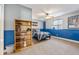 Inviting bedroom with blue accents, a comfortable bed, and a window providing natural light and a cozy atmosphere at 6950 Blue Mesa Ln, Littleton, CO 80125