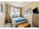 Cozy bedroom with eclectic decor, a comfortable bed, and ample natural light from the window at 6950 Blue Mesa Ln, Littleton, CO 80125