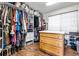 Spacious walk-in closet with custom shelving, drawers and ample storage for clothing and accessories at 6950 Blue Mesa Ln, Littleton, CO 80125