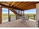 Charming covered patio with outdoor seating and scenic views of the open landscape at 6950 Blue Mesa Ln, Littleton, CO 80125