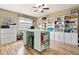 Spacious craft room featuring a large work table, ample storage shelves, and wood flooring at 6950 Blue Mesa Ln, Littleton, CO 80125