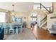 Bright dining room with a chandelier and painted blue dining set near the staircase at 6950 Blue Mesa Ln, Littleton, CO 80125