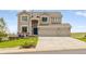 Charming two-story home featuring a three-car garage and a well-manicured front lawn at 6950 Blue Mesa Ln, Littleton, CO 80125