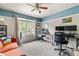 Well-lit home office featuring neutral walls, a ceiling fan, and two workstations with comfortable seating at 6950 Blue Mesa Ln, Littleton, CO 80125