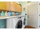 Functional laundry room with modern washer and dryer, plenty of storage, and a convenient layout at 6950 Blue Mesa Ln, Littleton, CO 80125