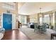Open-concept room with a dining area and large front door at 6950 Blue Mesa Ln, Littleton, CO 80125