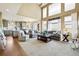 Spacious living room with large windows and an open layout connected to the kitchen area at 6950 Blue Mesa Ln, Littleton, CO 80125