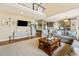 Open concept living room with hardwood floors and seamless transition to the modern kitchen at 6950 Blue Mesa Ln, Littleton, CO 80125