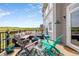 Relaxing outdoor deck featuring comfortable seating with expansive views of the surrounding landscape at 6950 Blue Mesa Ln, Littleton, CO 80125