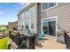 Inviting outdoor deck with comfortable seating, grill, and access to the interior through sliding glass doors at 6950 Blue Mesa Ln, Littleton, CO 80125
