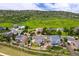 Aerial view featuring the home in a suburban neighborhood, backing onto lush greenery and open space at 6950 Blue Mesa Ln, Littleton, CO 80125