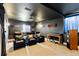 Basement home theater with reclining chairs, projector, and dark walls for an immersive cinematic experience at 6950 Blue Mesa Ln, Littleton, CO 80125