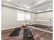 Basement fitness area with wood floors, a full wall mirror, and plenty of natural light at 2880 Emporia Ct, Denver, CO 80238