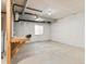 Unfinished basement features a workbench, window, and painted concrete floor ready for customization at 2880 Emporia Ct, Denver, CO 80238