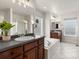 Bright bathroom with a double sink vanity, soaking tub, and glass block window at 2880 Emporia Ct, Denver, CO 80238