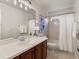 Cozy bathroom features a vanity with drawers and a shower-tub combo with tile surround at 2880 Emporia Ct, Denver, CO 80238