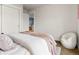 Bright bedroom boasts an open layout with a closet, door, and white chair at 2880 Emporia Ct, Denver, CO 80238