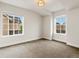 Bright bedroom with neutral carpet, plenty of natural light, and fresh white trim at 2880 Emporia Ct, Denver, CO 80238