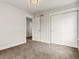 Clean bedroom with large closet and a door to an adjacent room at 2880 Emporia Ct, Denver, CO 80238