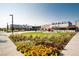 Eye level view of Stanley Marketplace, enhanced by vibrant flowers and landscaping, welcomes visitors at 2880 Emporia Ct, Denver, CO 80238
