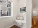 Cozy entryway nook with a cushioned bench seat, pillows, and a window providing natural light at 2880 Emporia Ct, Denver, CO 80238