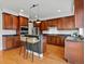 Spacious kitchen featuring wooden cabinets, stainless steel appliances, and a center island with bar seating at 2880 Emporia Ct, Denver, CO 80238