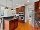 Well-lit kitchen with wooden cabinets, stainless steel oven and microwave, and access to multiple rooms at 2880 Emporia Ct, Denver, CO 80238