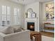 Comfortable living room with a fireplace, large windows, and elegant decor at 2880 Emporia Ct, Denver, CO 80238